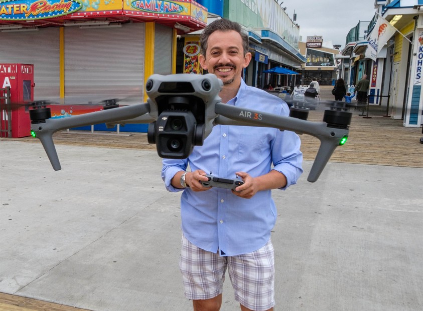 Joe Martucci flying a drone on the boardwalk.
